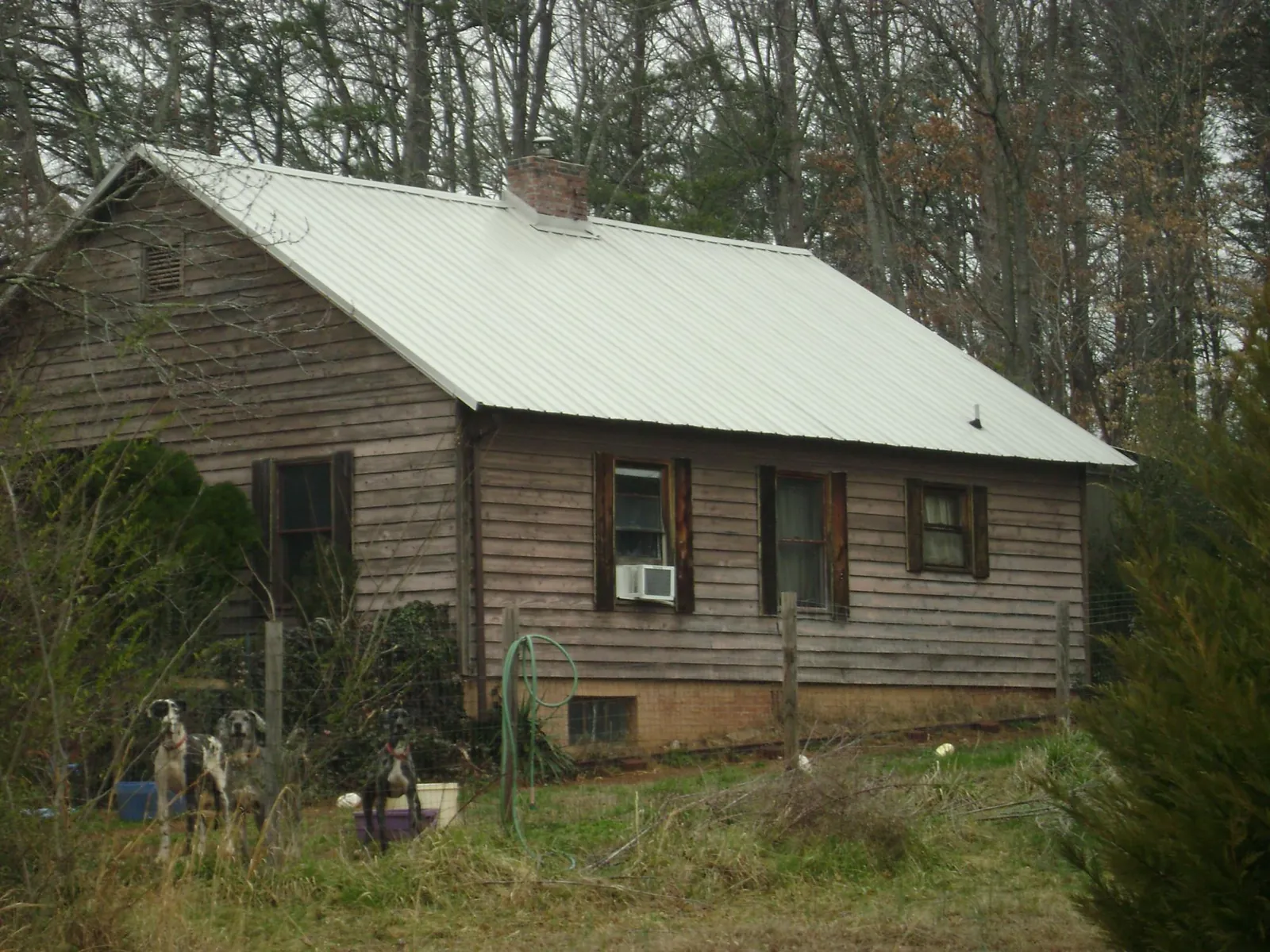 White metal roof on an old wood sided farmhouse, from a Metal Roof Installation job in Branchdale